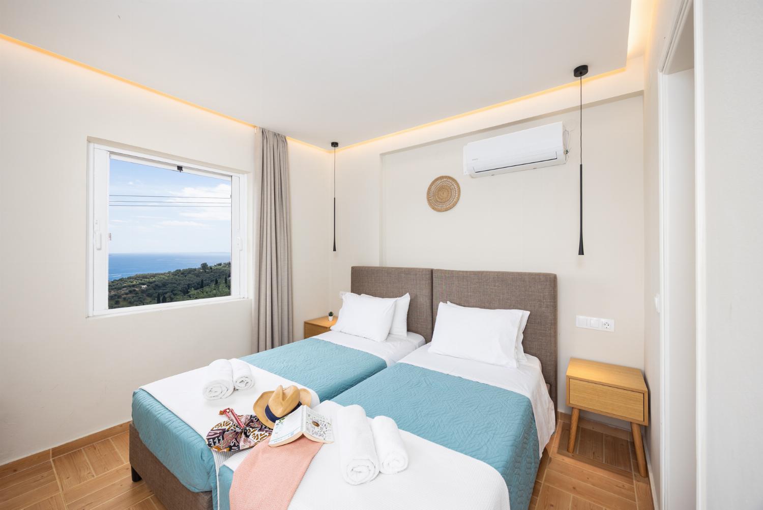 Twin bedroom with en suite bathroom, A/C, and sea views