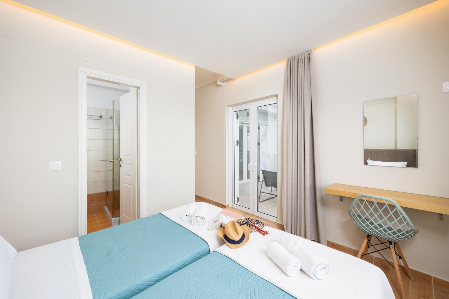 Twin bedroom with en suite bathroom, A/C, and sea views