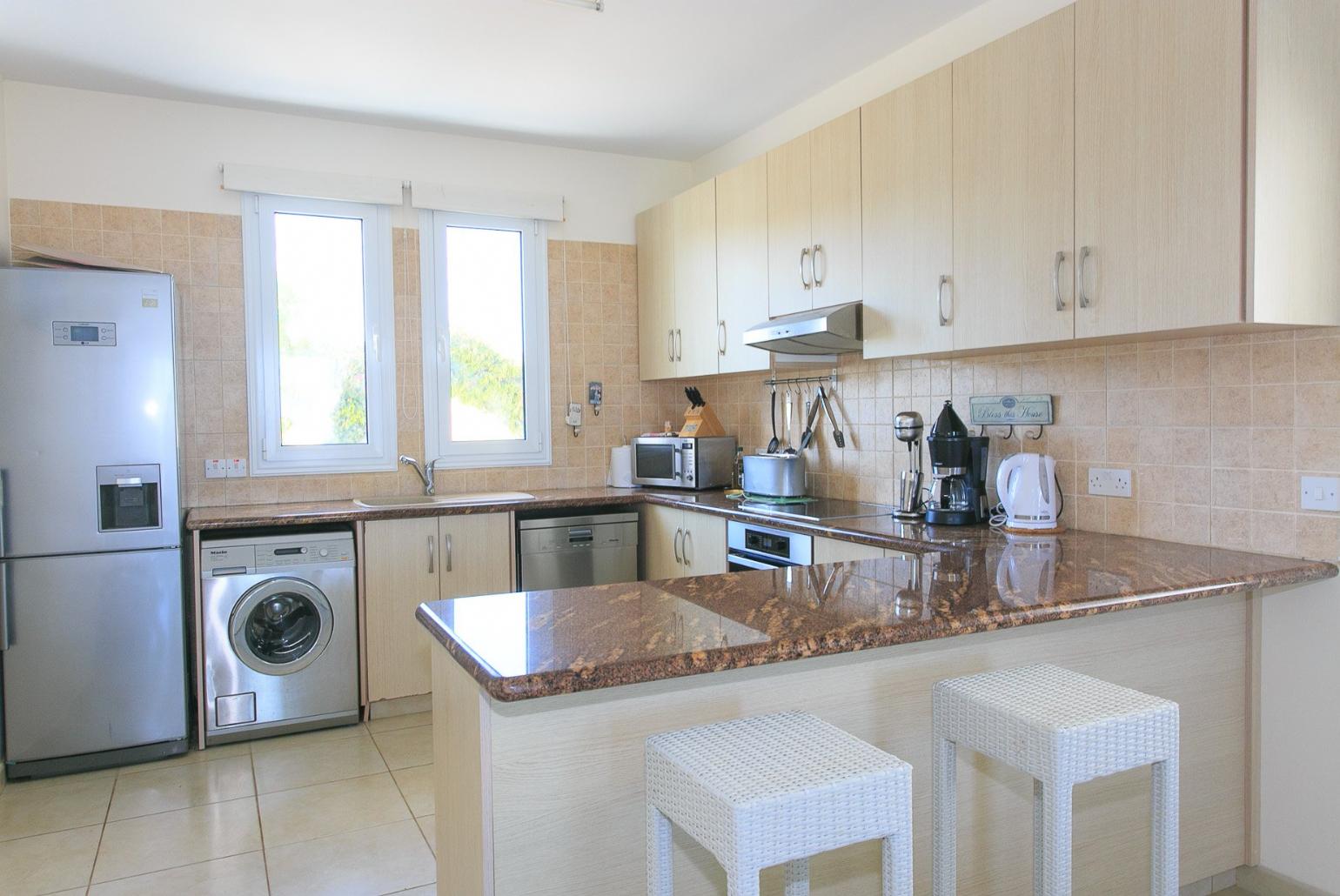 Equipped open plan kitchen and breakfast bar