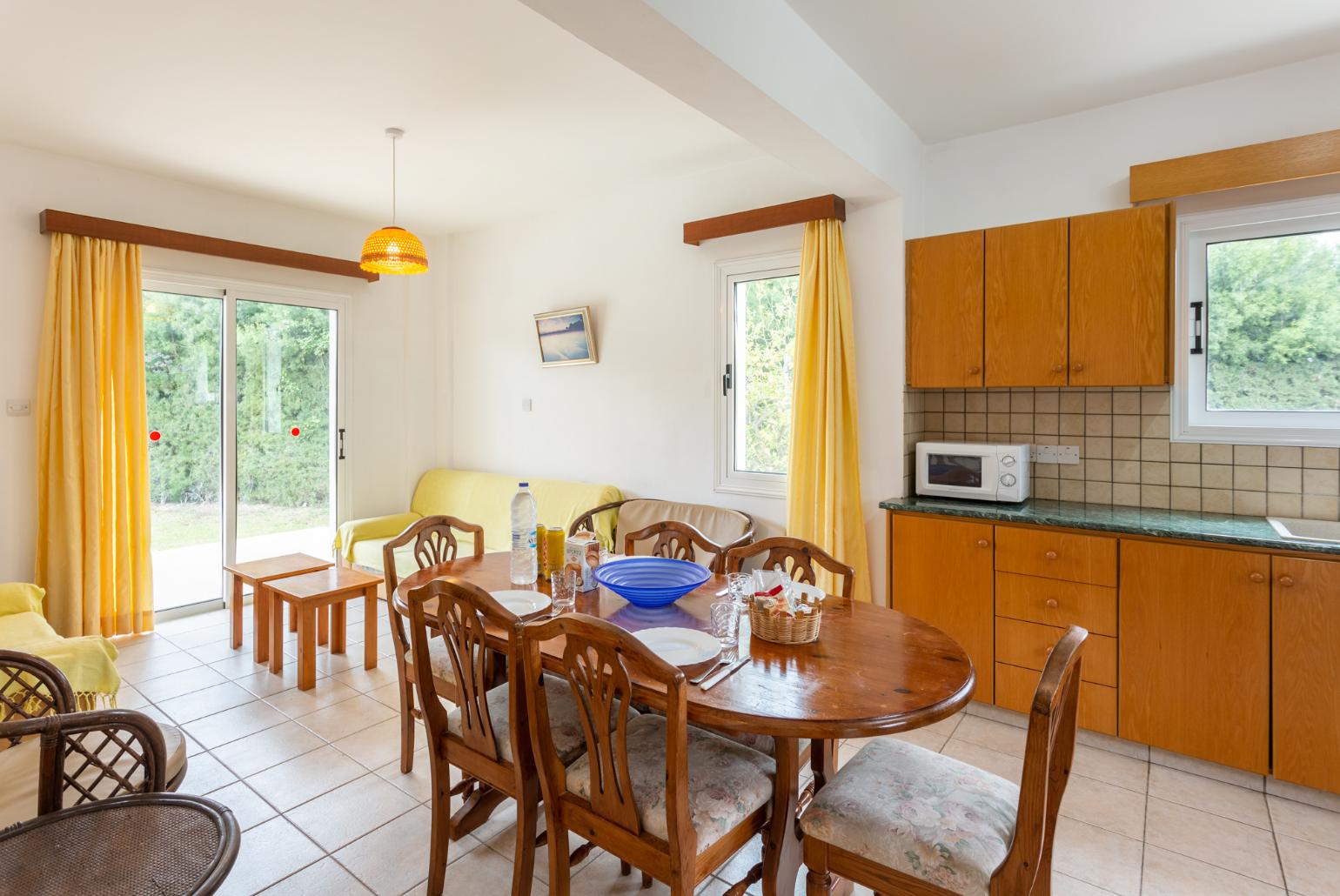 Open-plan living room with sofas, dining area, kitchen, ornamental fireplace, WiFi internet, and satellite TV