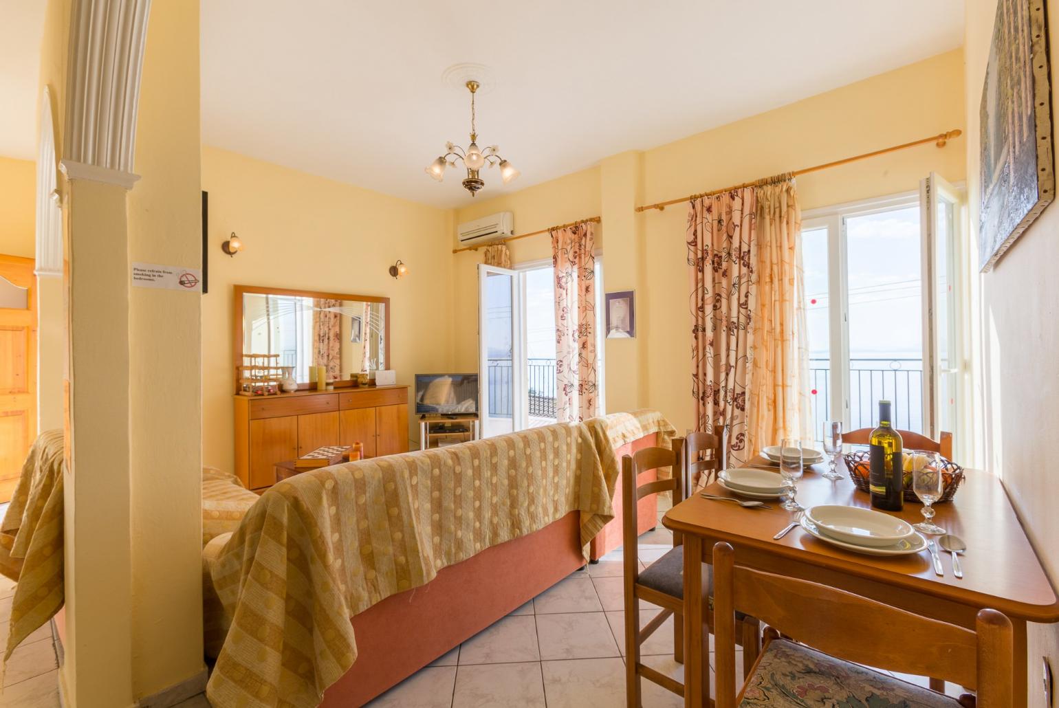 Open-plan living room with WiFi Internet, Satellite TV, DVD player, dining area, equipped kitchen and balcony access