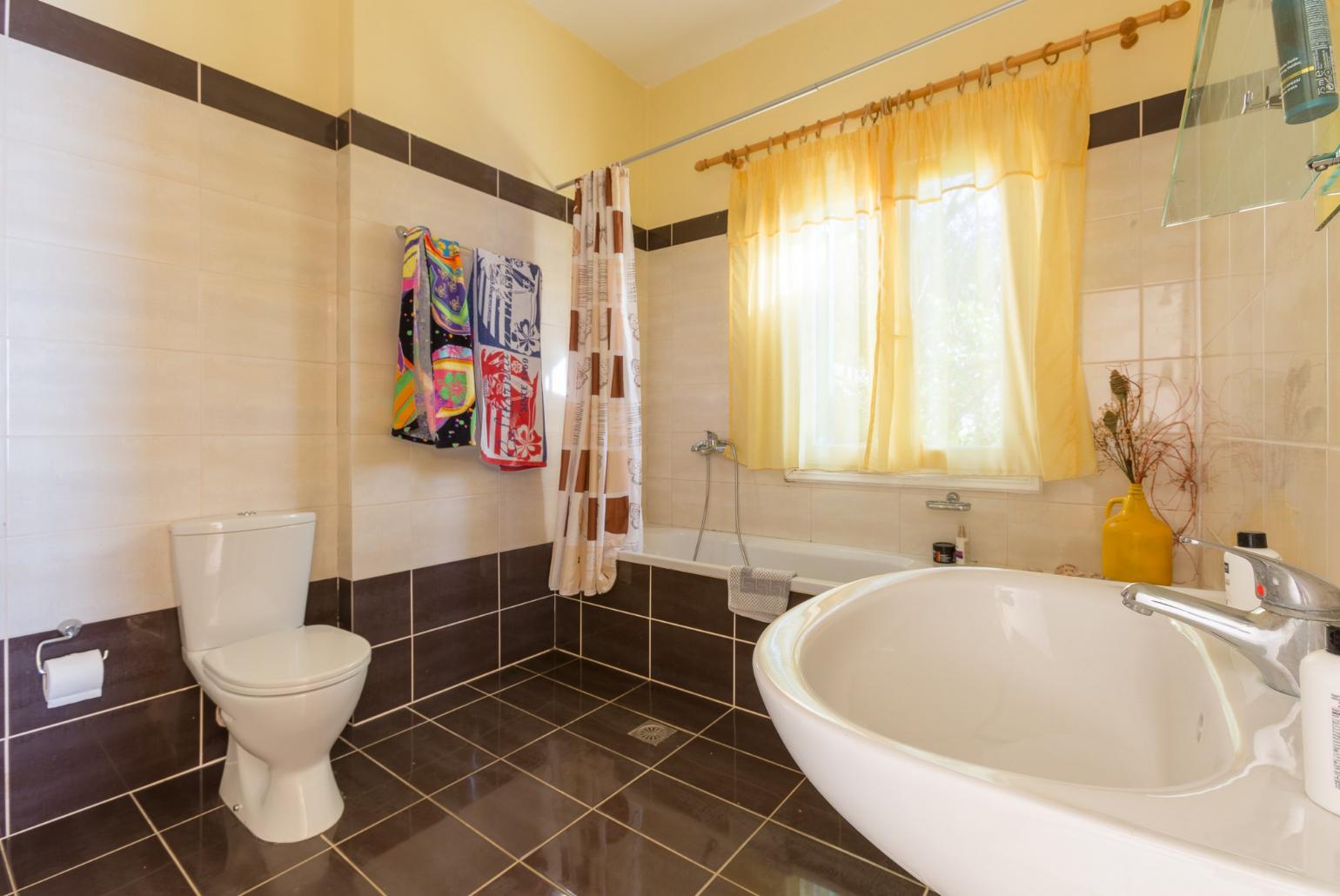 Bathroom with bath and overhead shower
