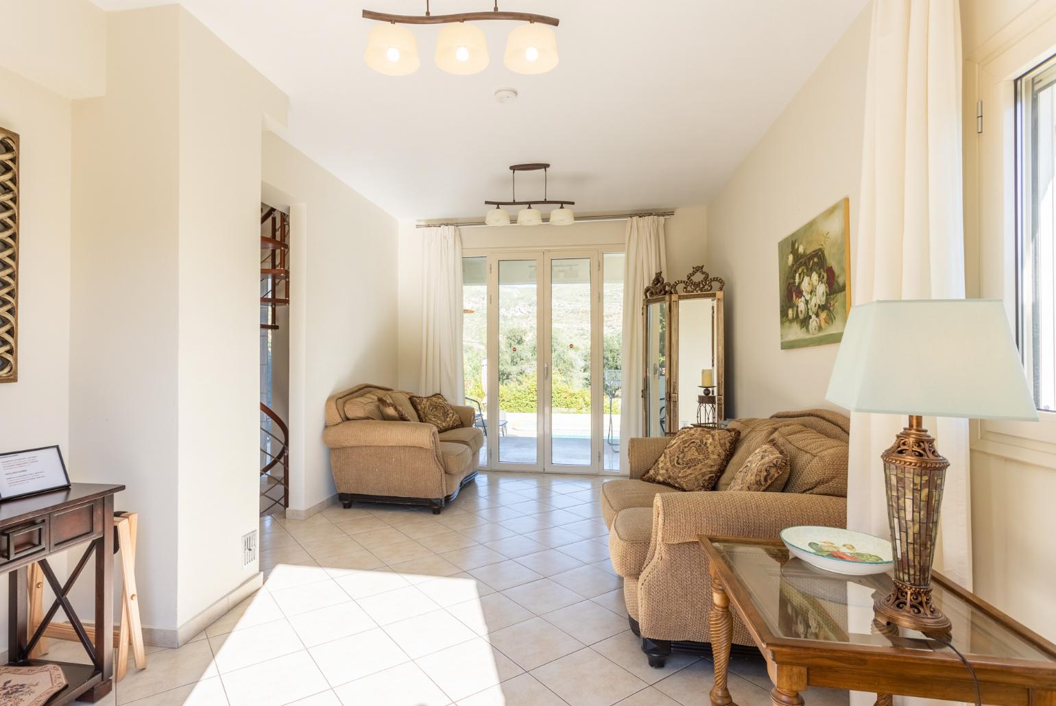 Living room on first floor with sofas, A/C, WiFi internet, satellite TV, and terrace access