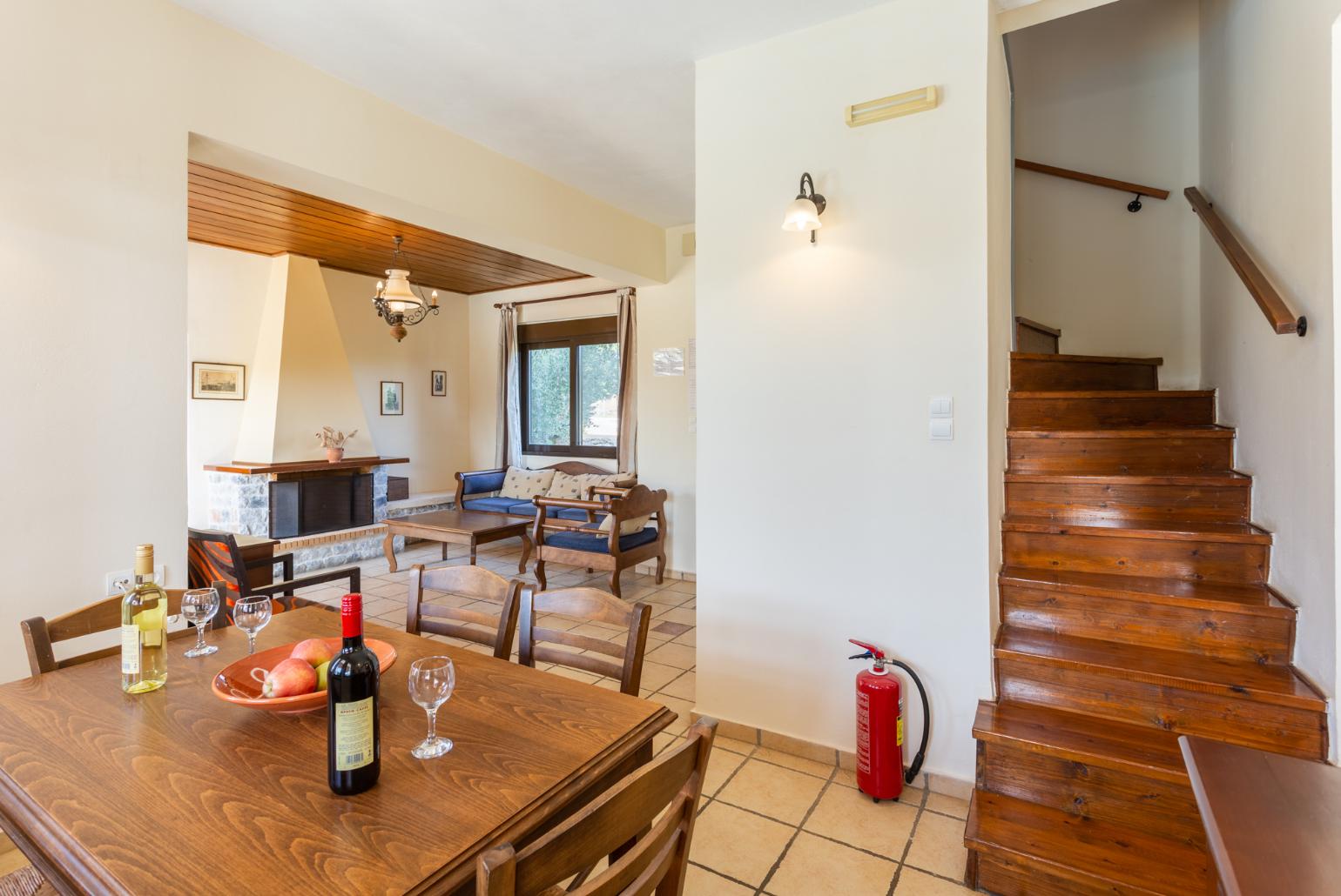 Living room with sofa, dining area, ornamental fireplace, WiFi internet, satellite TV, DVD player, and pool terrace access