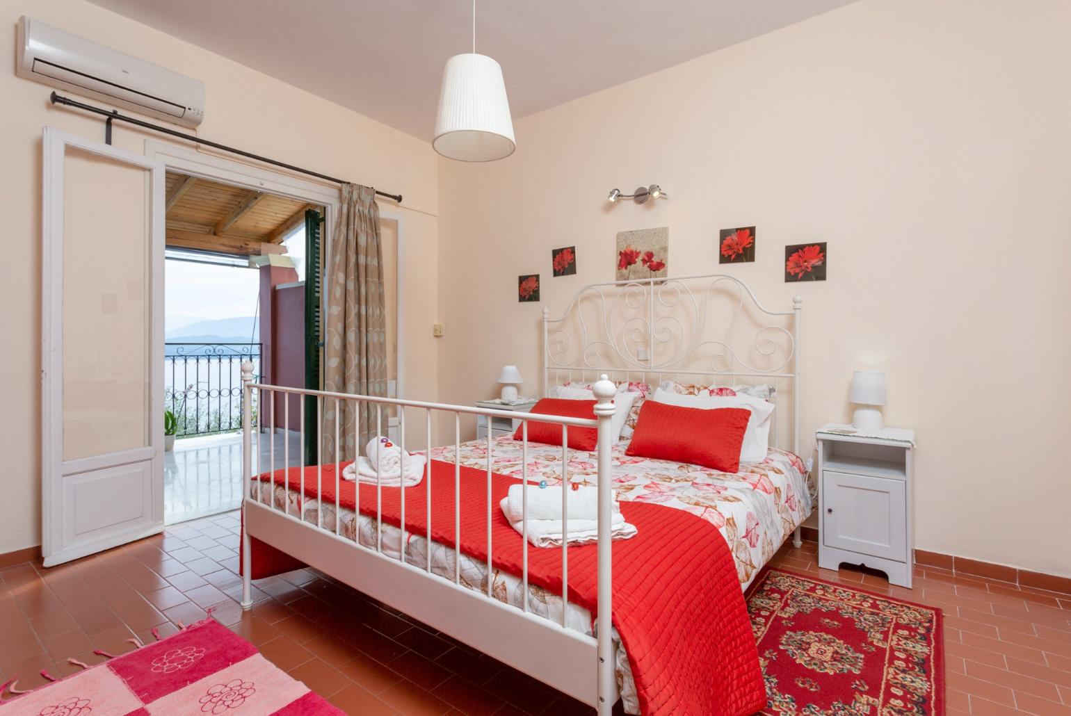 Double bedroom on first floor with A/C and balcony access with sea views