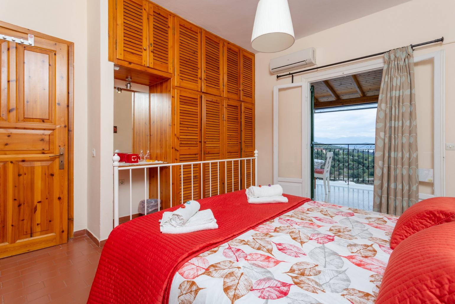 Double bedroom on first floor with A/C and balcony access with sea views