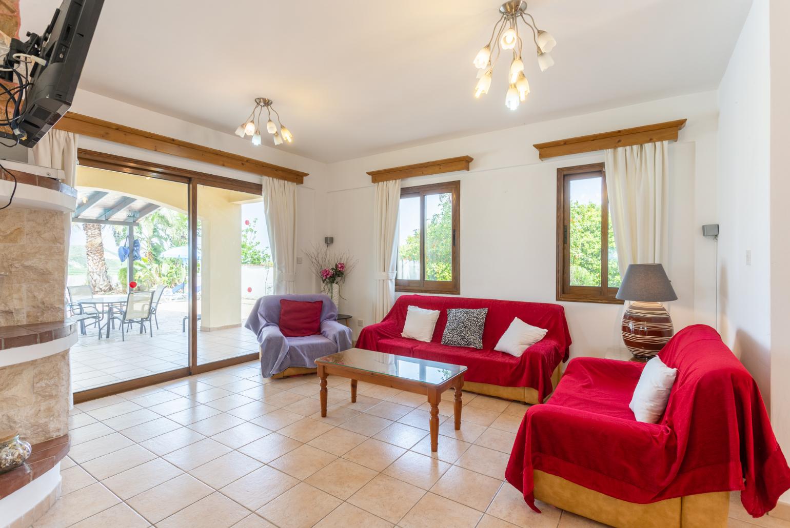 Open-plan living room with sofas, dining area, kitchen, ornamental fireplace, WiFi internet, and satellite TV