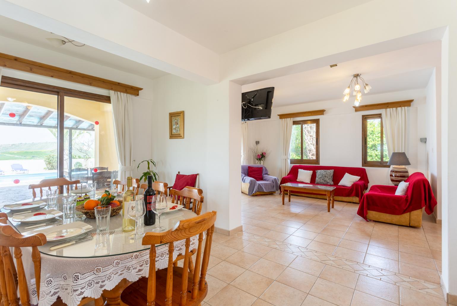 Open-plan living room with sofas, dining area, kitchen, ornamental fireplace, WiFi internet, and satellite TV