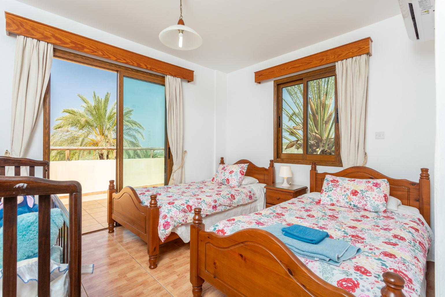 Twin bedroom with en suite bathroom, A/C, and upper terrace access