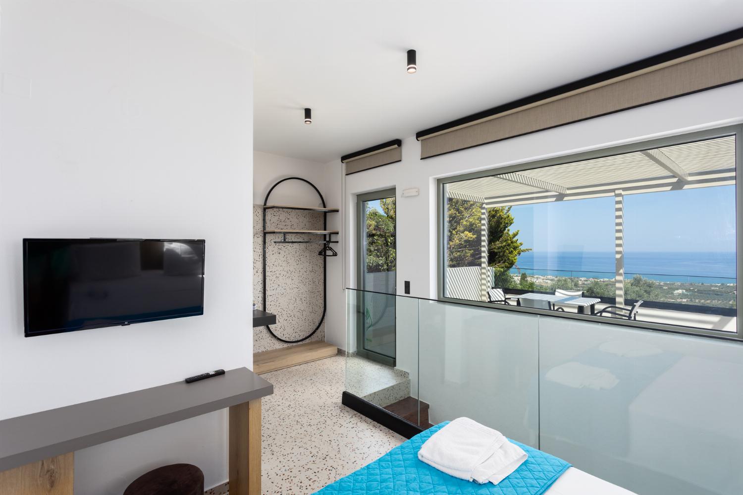 Double bedroom with en suite bathroom, A/C, TV, and sea views
