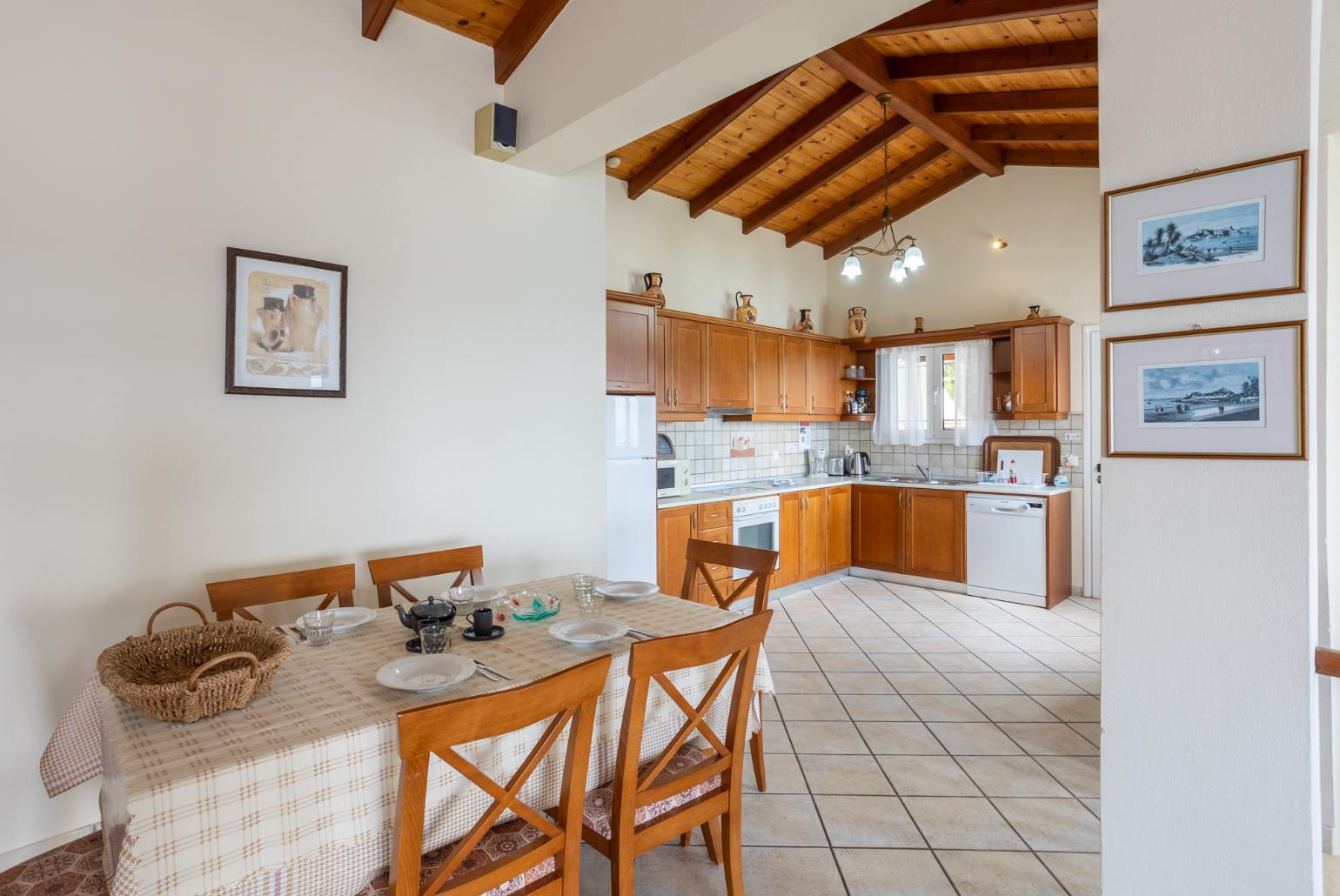 Open-plan living room with sofas, dining area, kitchen, ornamental fireplace, WiFi internet, satellite TV, and sea views