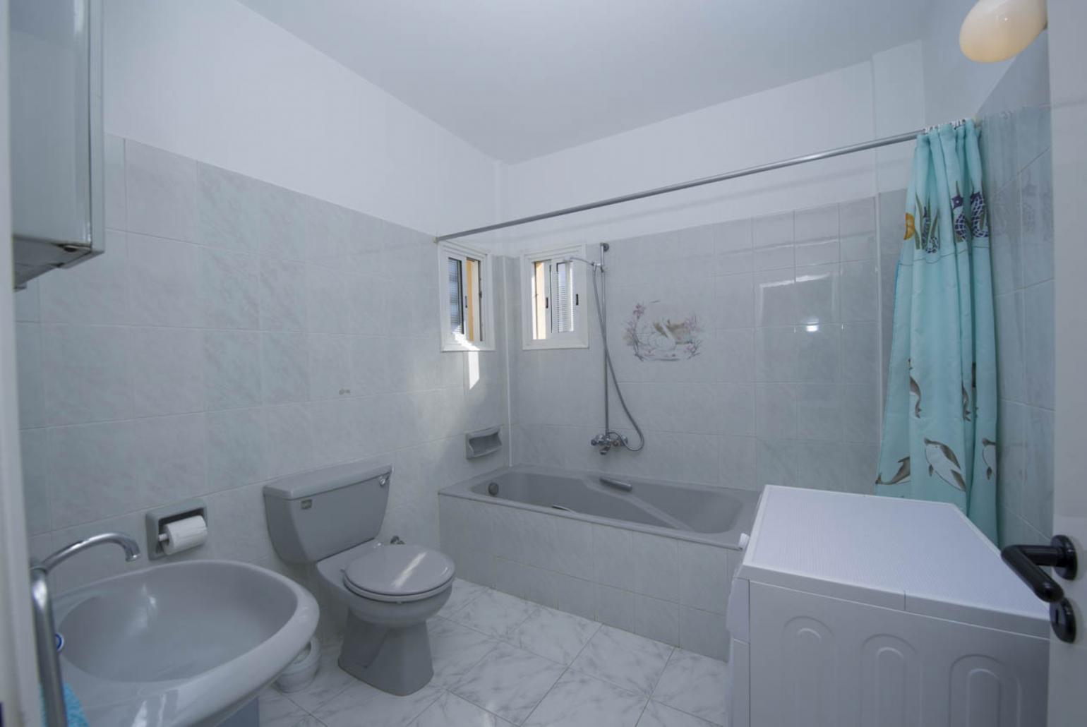 Bathroom with bath and overhead shower