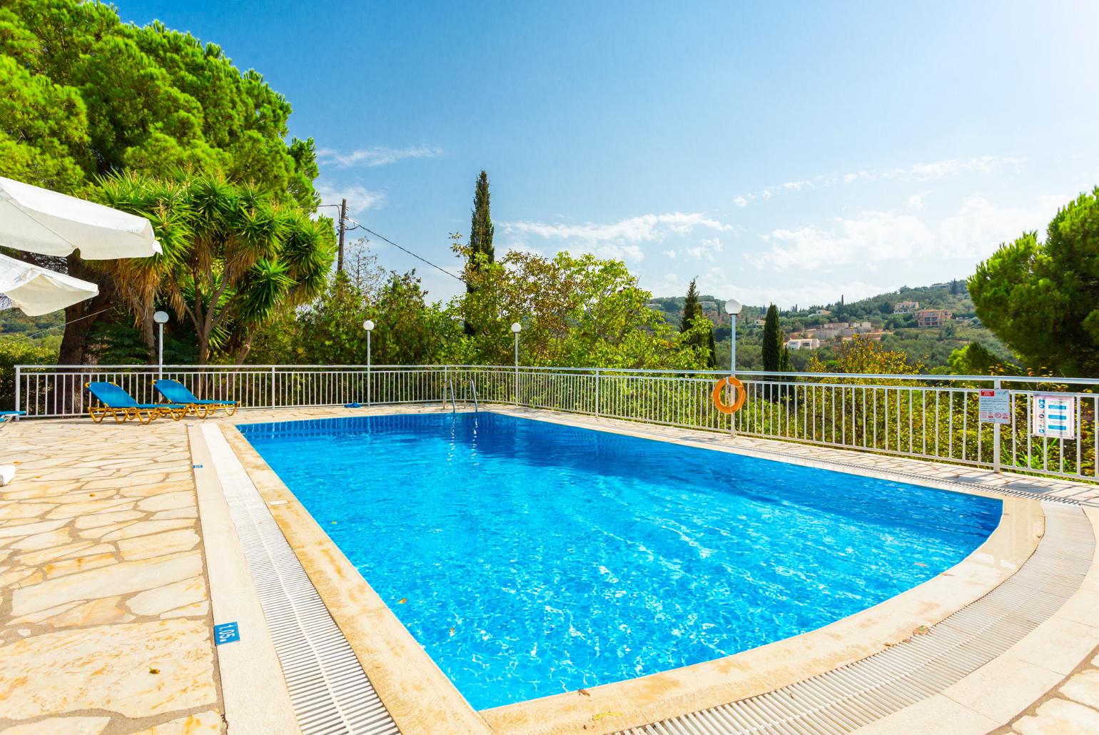 Shared pool, terrace, and garden with countryside views