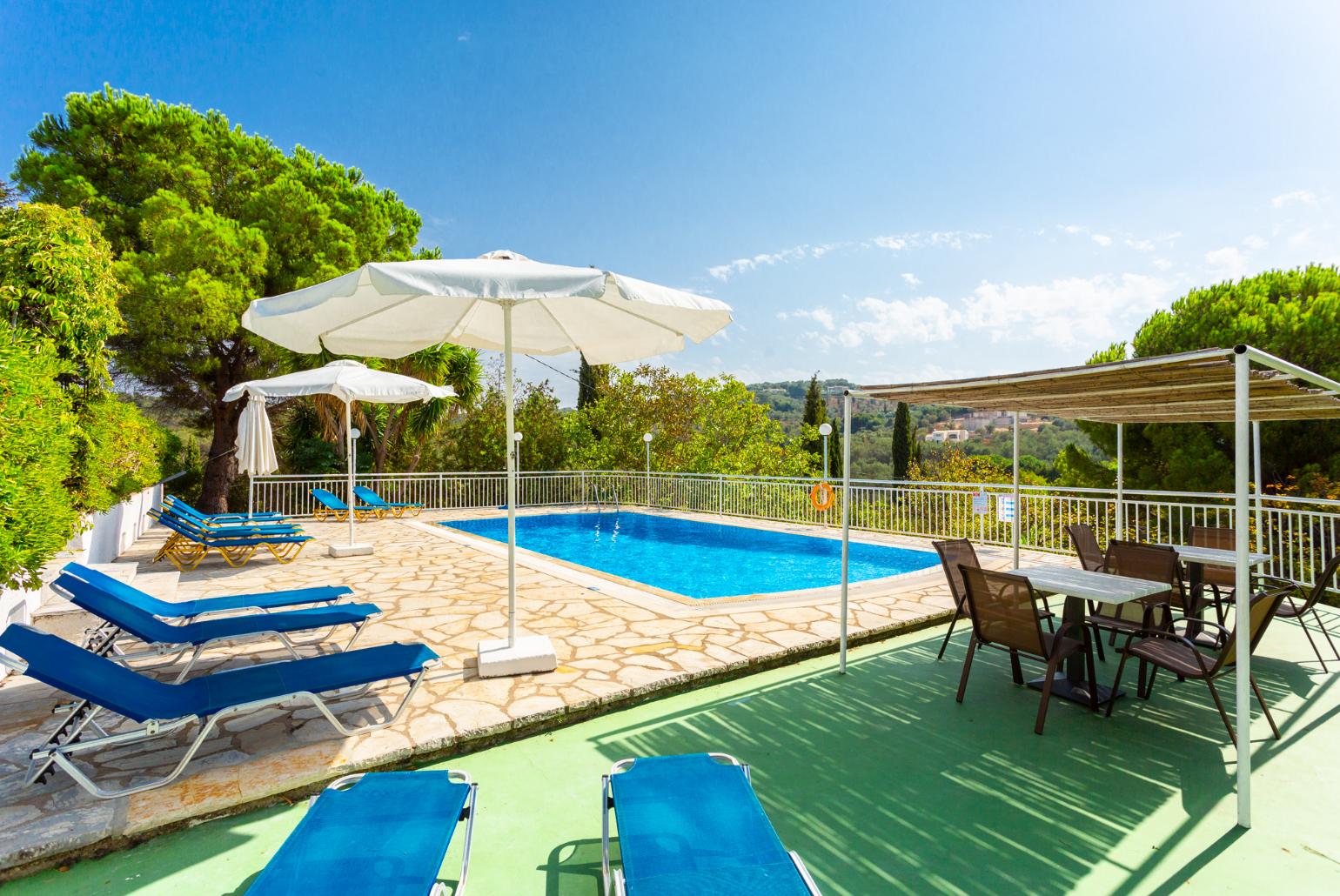 Shared pool, terrace, and garden with countryside views