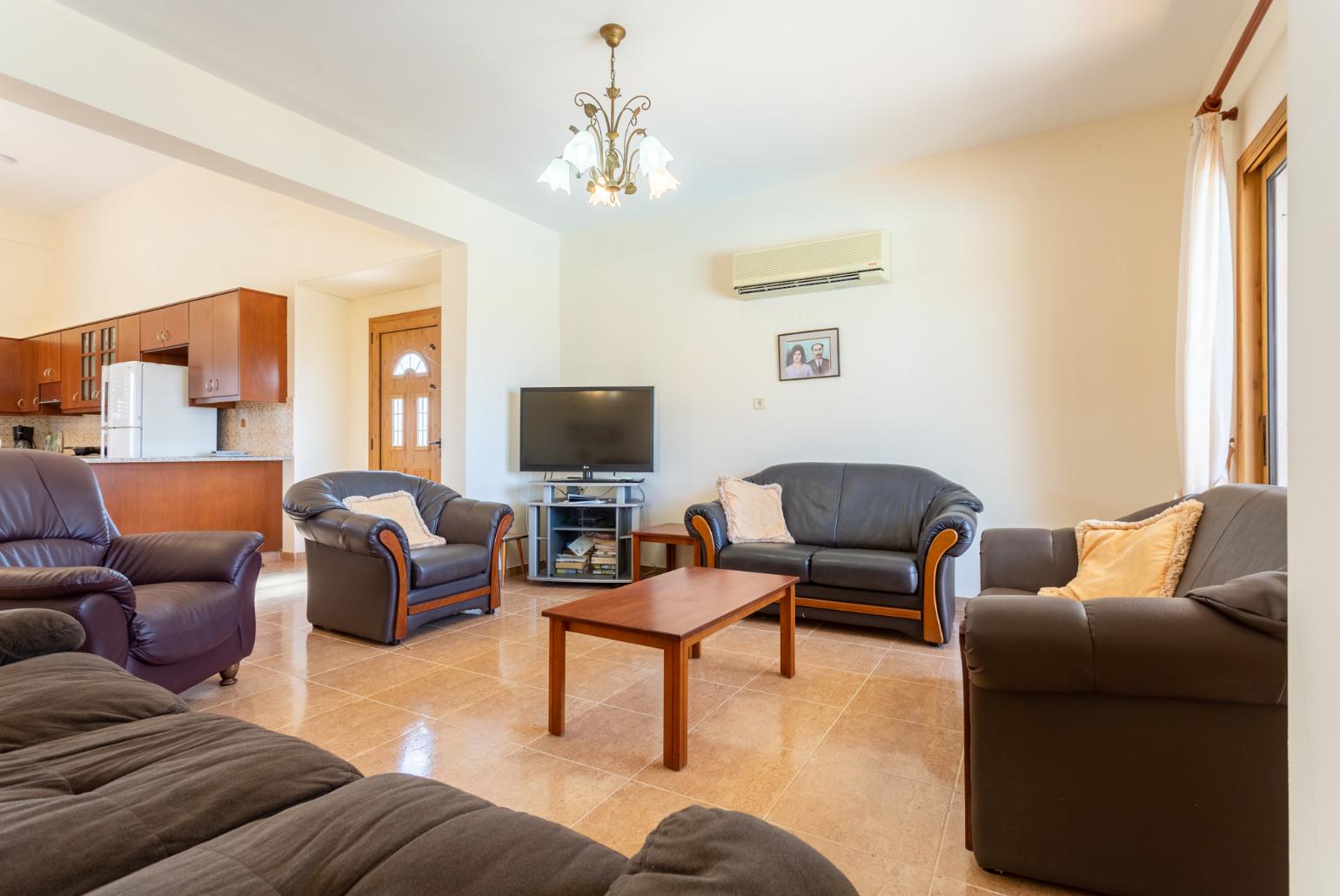 Open-plan living room with sofas, dining areas, kitchen, A/C, WiFi internet, satellite TV, and terrace access
