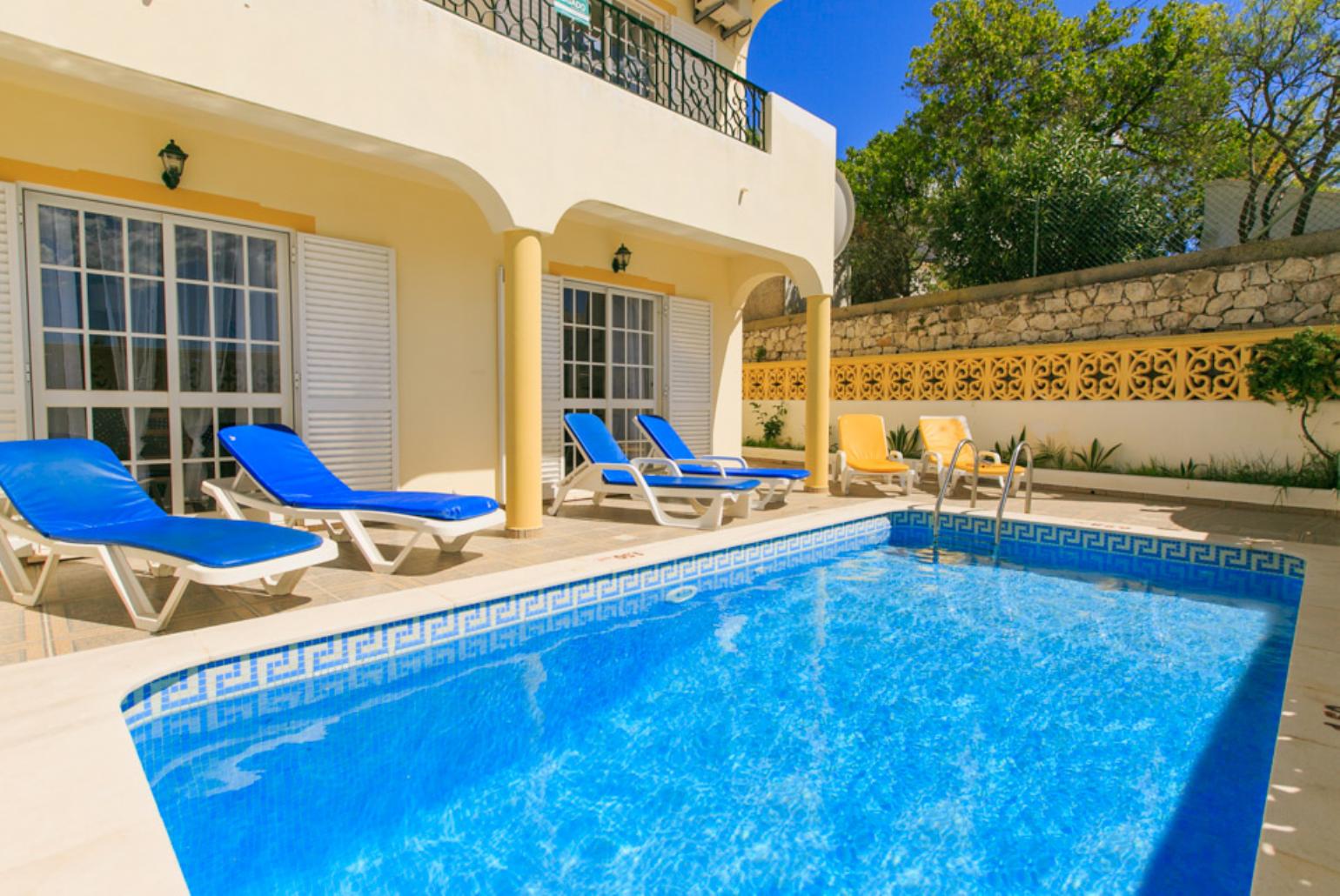 Swimming pool with sun loungers