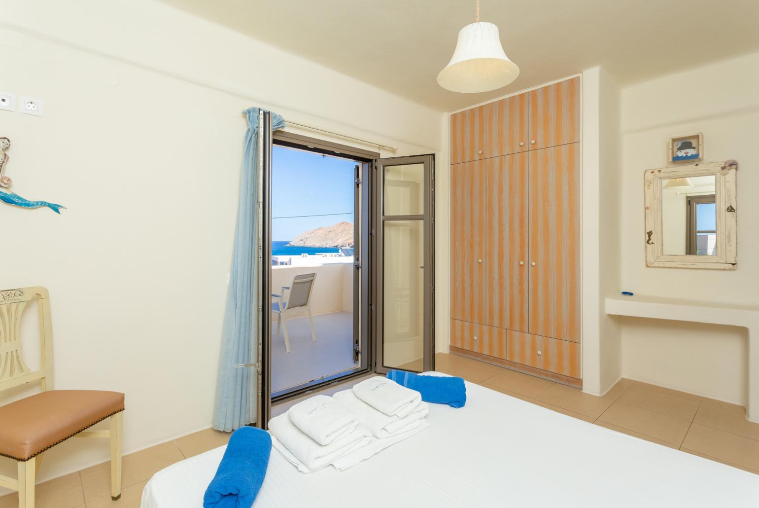 Double bedroom with en suite bathroom, A/C, and balcony with sea views