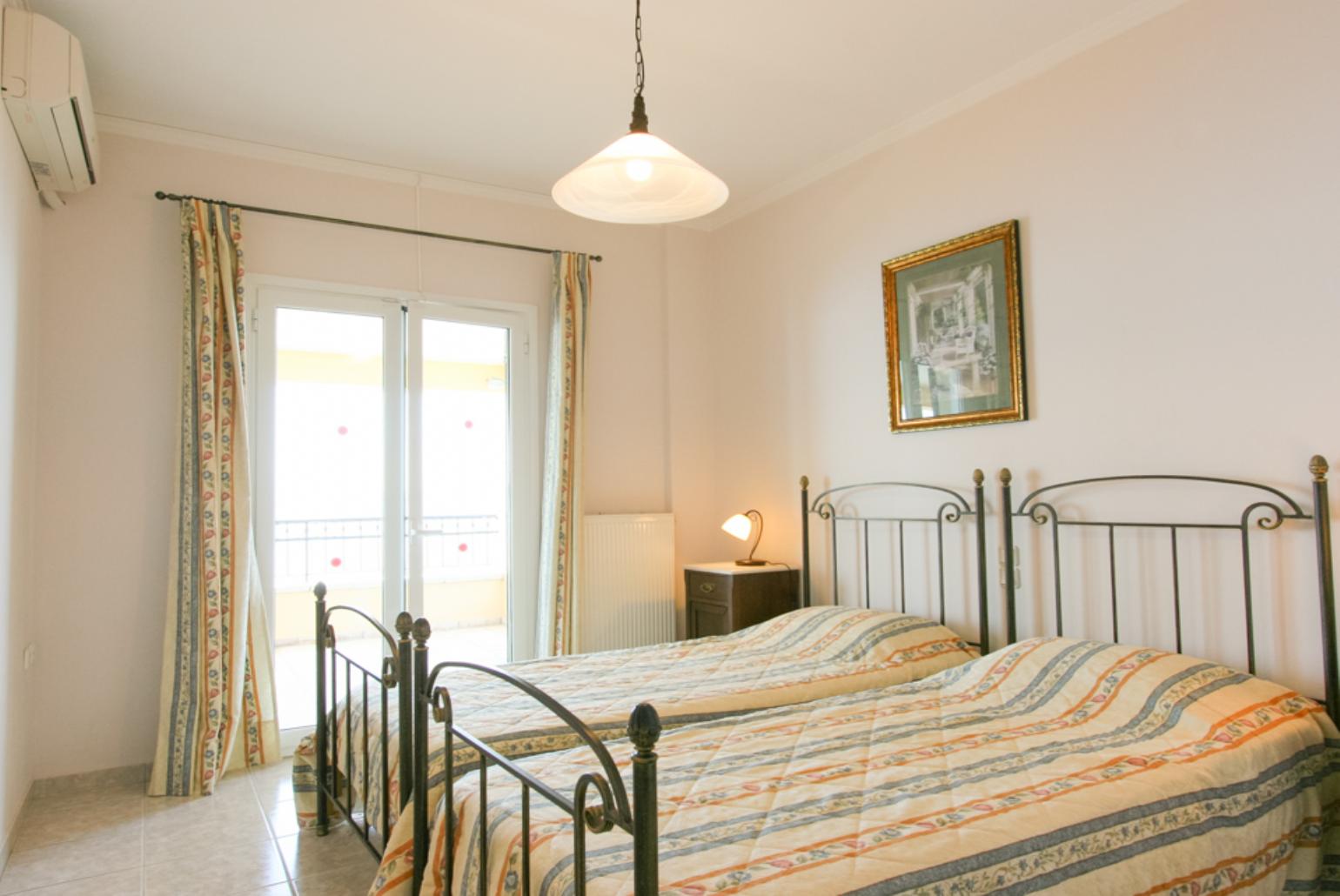 Twin bedroom with A/C and balcony access