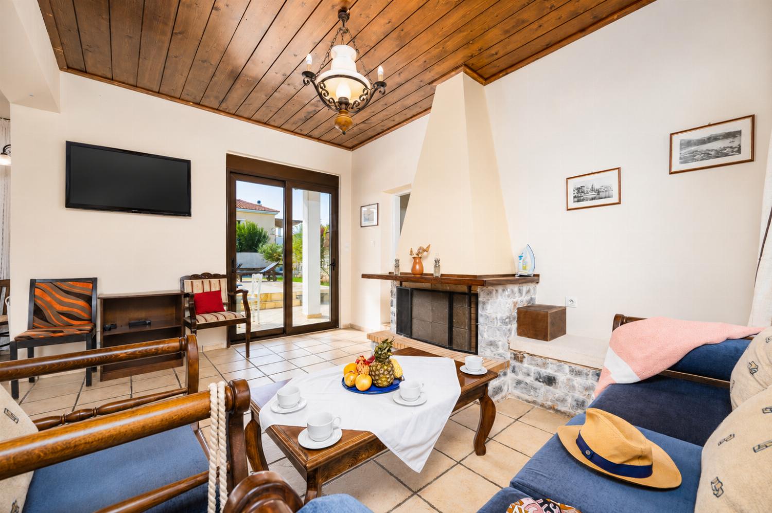 Living room with sofa, ornamental fireplace, WiFi internet, and satellite TV