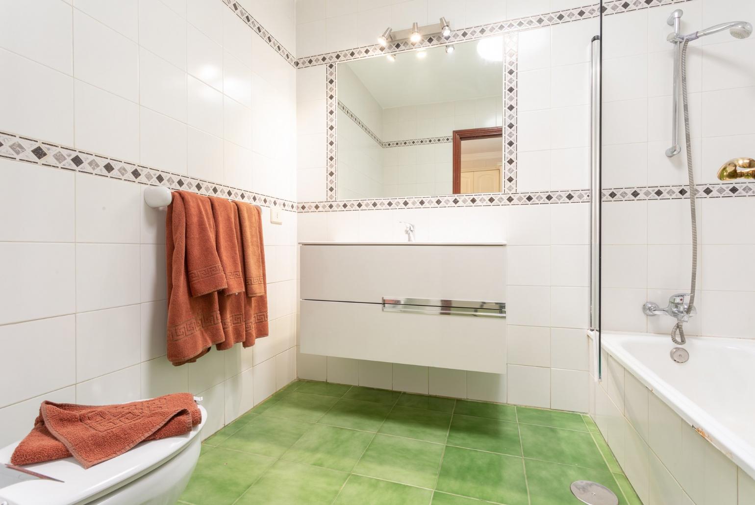 Family bathroom with bath and overhead shower