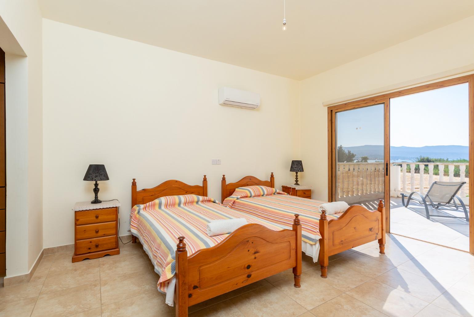 Twin bedroom with en suite bathroom, A/C, and upper terrace access