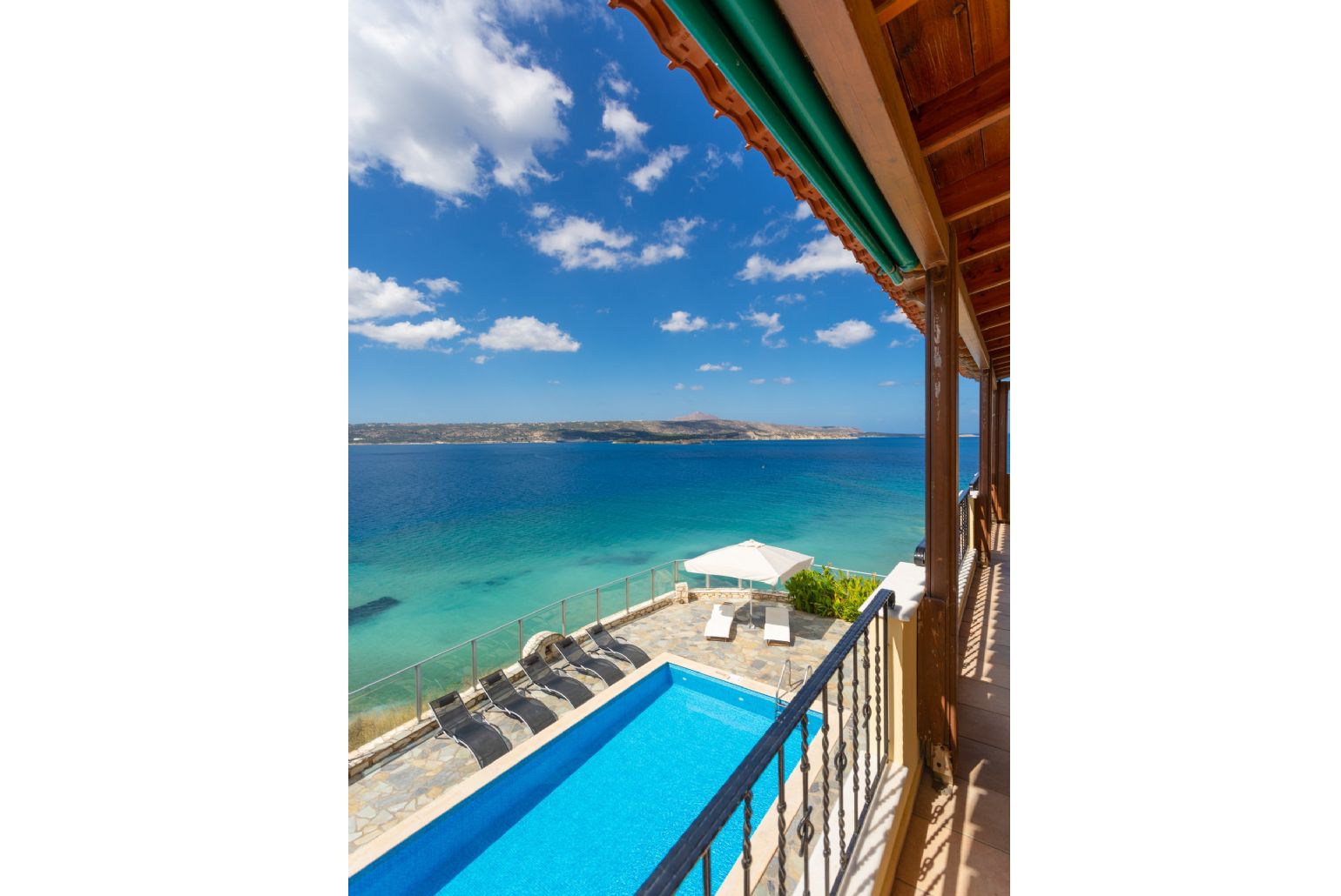 Sheltered balcony with outdoor seating and panoramic sea views