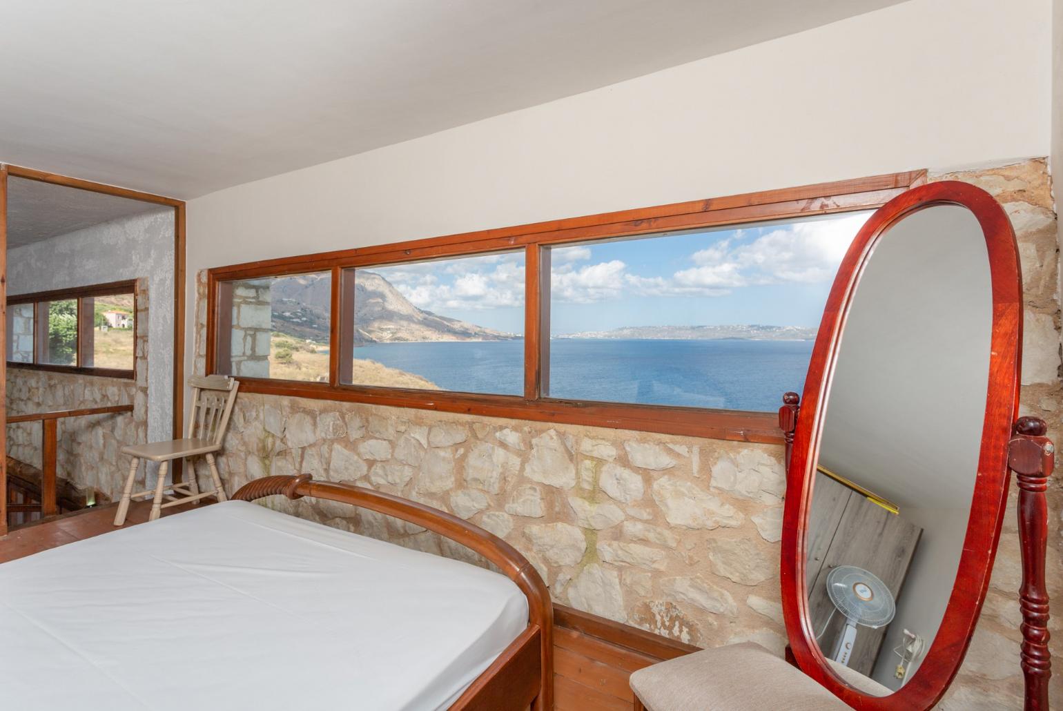 Double bedroom on mezzanine of self-contained apartment with panoramic sea views
