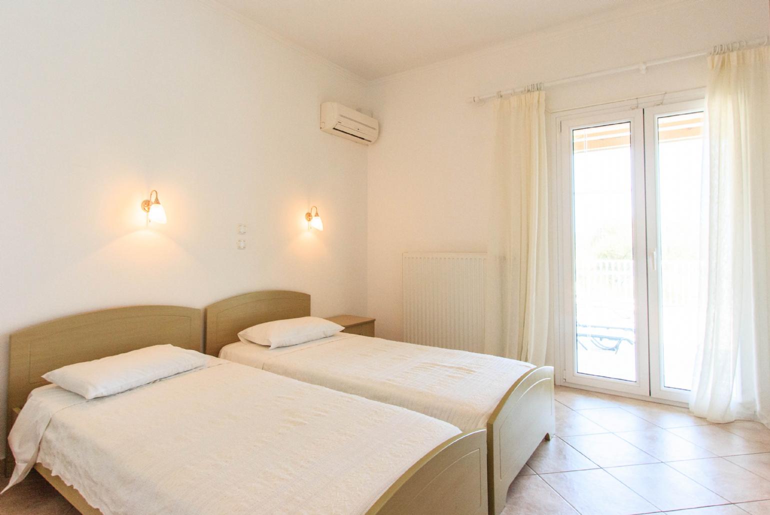 Twin bedroom with A/C and balcony access