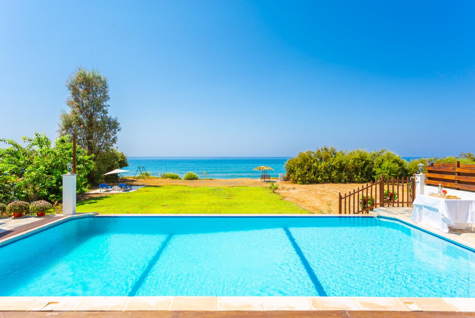 Private infinity pool, terrace, and garden with panoramic sea views