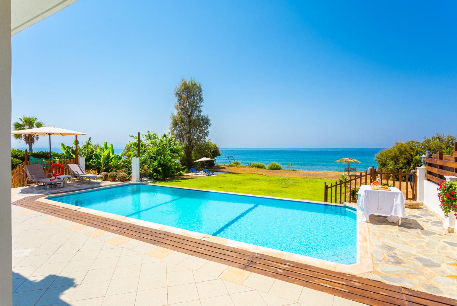 Private infinity pool, terrace, and garden with panoramic sea views