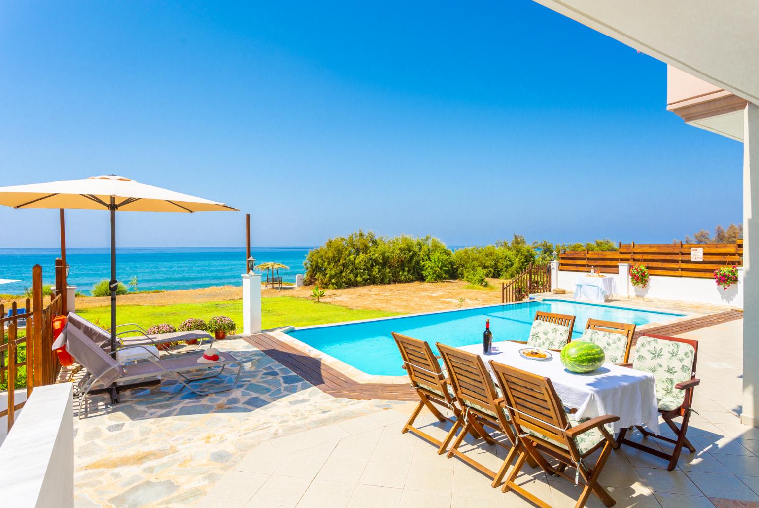 Private infinity pool, terrace area, and garden with panoramic sea views