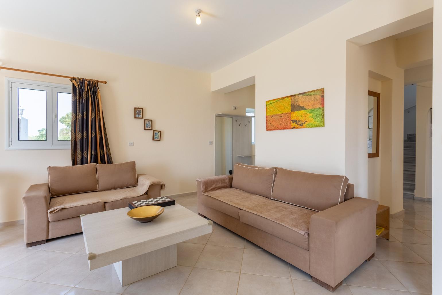 Open-plan living room with sofas, dining area, kitchen, ornamental fireplace, A/C, WiFi internet, satellite TV, pool table, foosball table, and terrace access with sea views