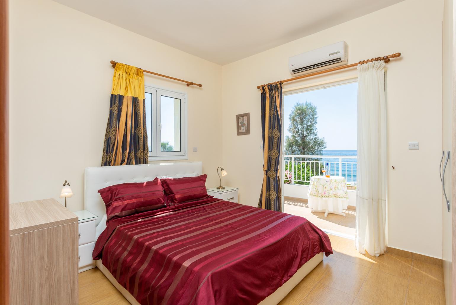 Double bedroom with en suite bathroom, A/C, and upper terrace access with panoramic sea views