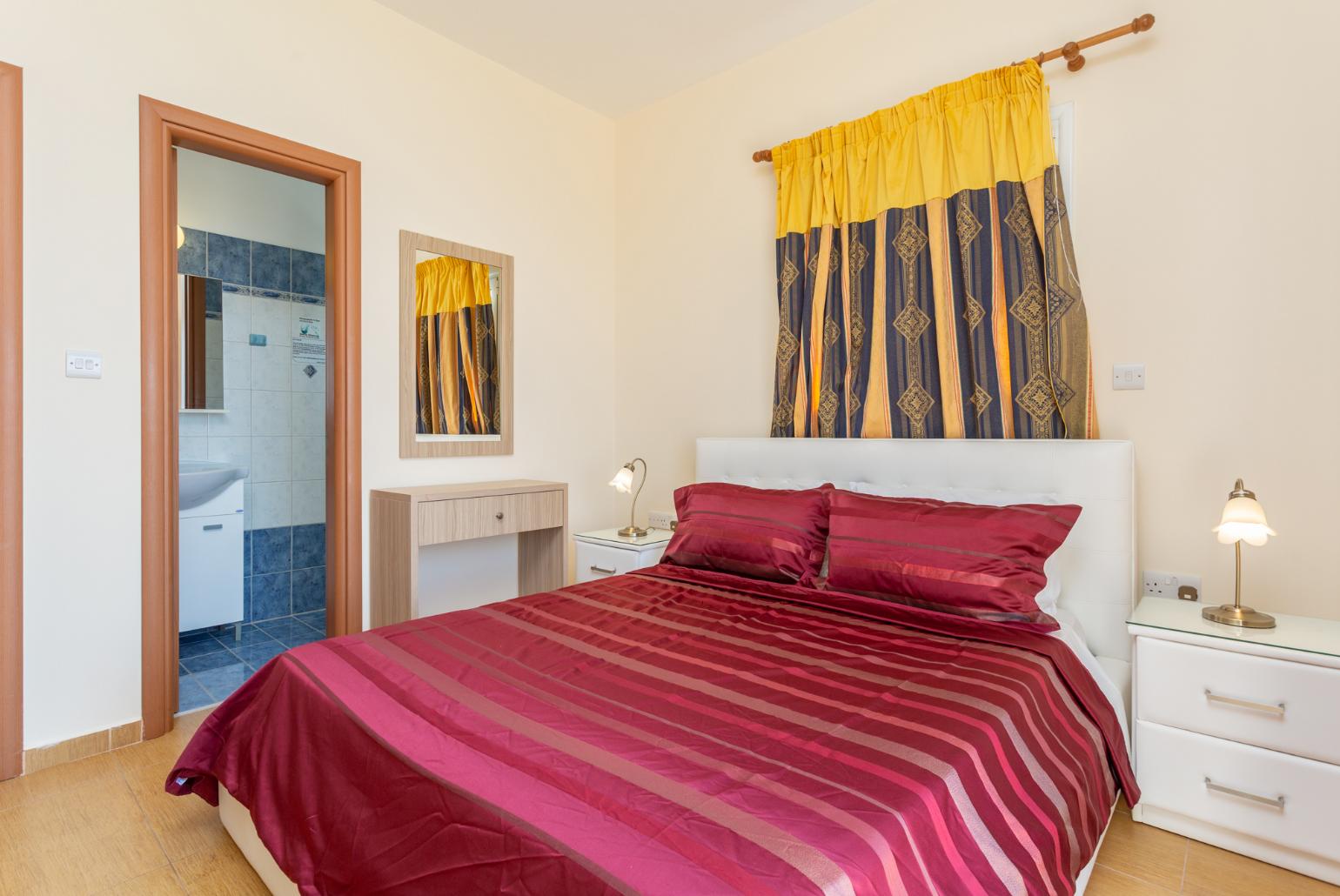 Double bedroom with en suite bathroom, A/C, and upper terrace access with panoramic sea views