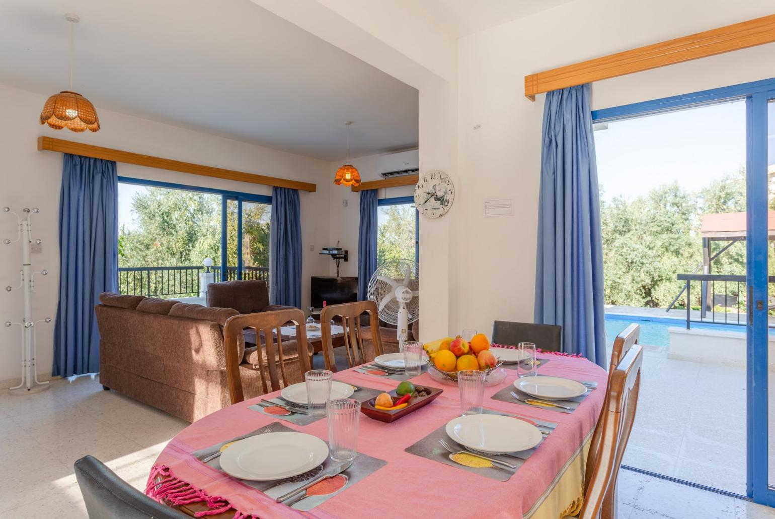 Open-plan living room with sofas, dining area, kitchen, A/C, WiFi internet, satellite TV, and terrace access