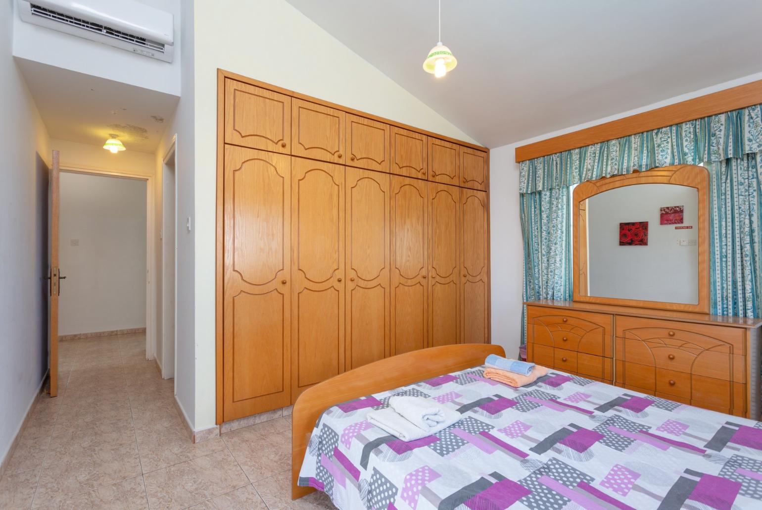 Double bedroom with en suite bathroom, A/C, and balcony access with sea views