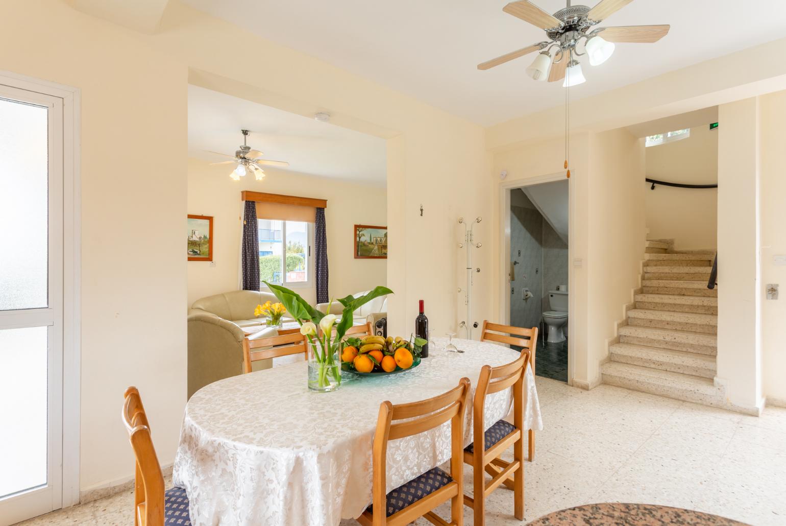 Open-plan living room with sofas, dining area, kitchen, WiFi internet, and satellite TV