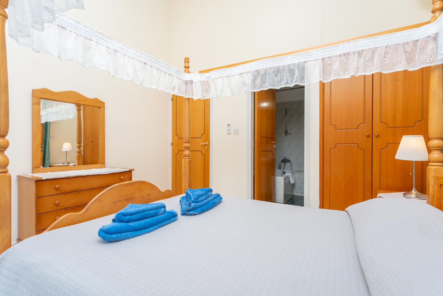 Double bedroom with en suite bathroom, A/C, and balcony access