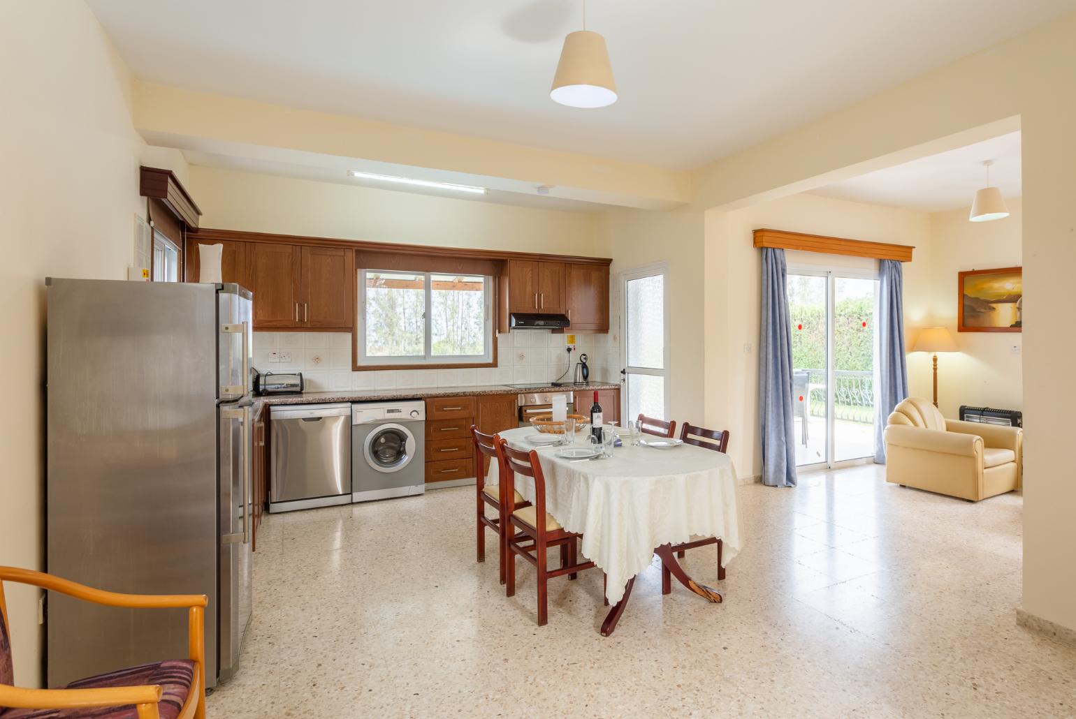 Open-plan living room with sofas, dining area, kitchen, WiFi internet, and satellite TV