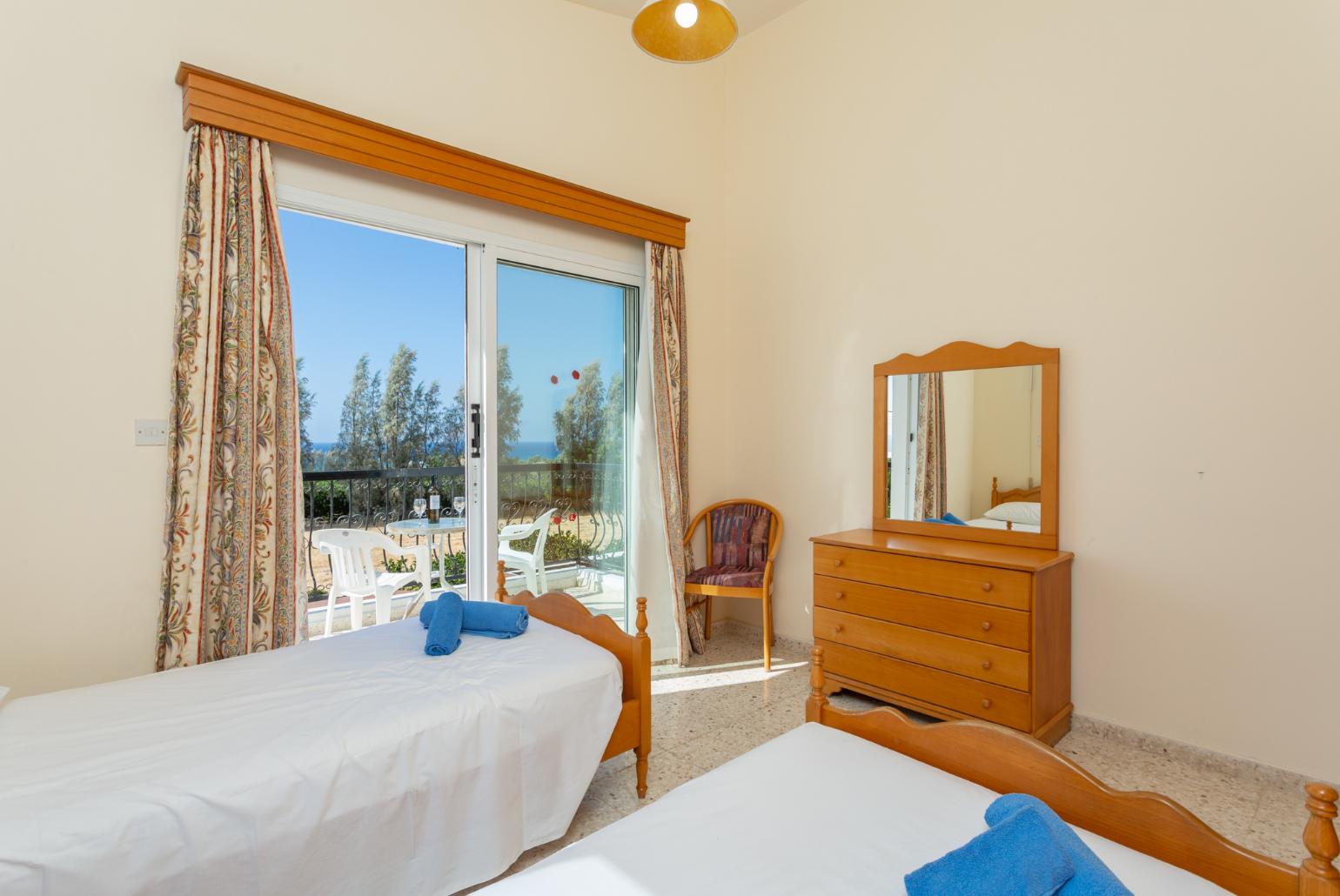 Twin bedroom with en suite bathroom, A/C, and balcony access with sea views