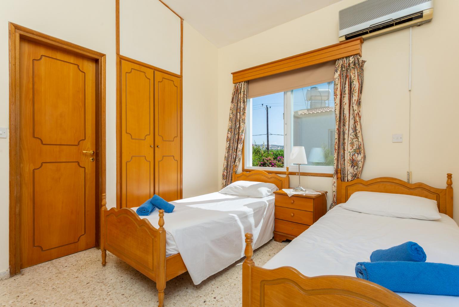 Twin bedroom with en suite bathroom, A/C, and balcony access with sea views