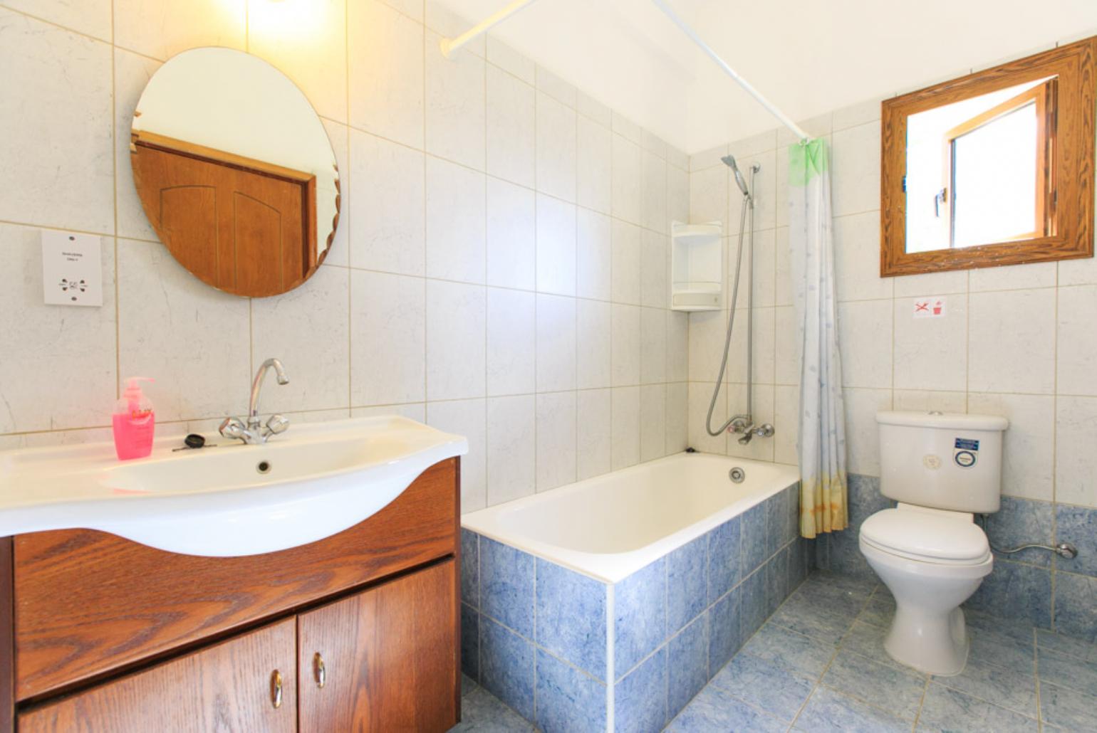 Bathroom with bath and overhead shower