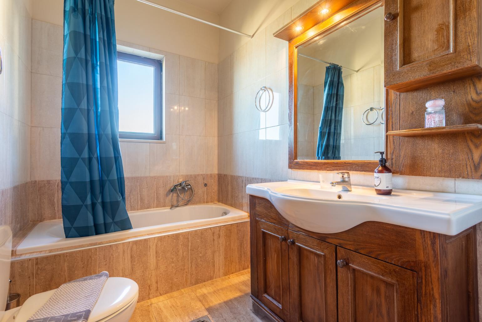 En suite bathroom with bath and shower