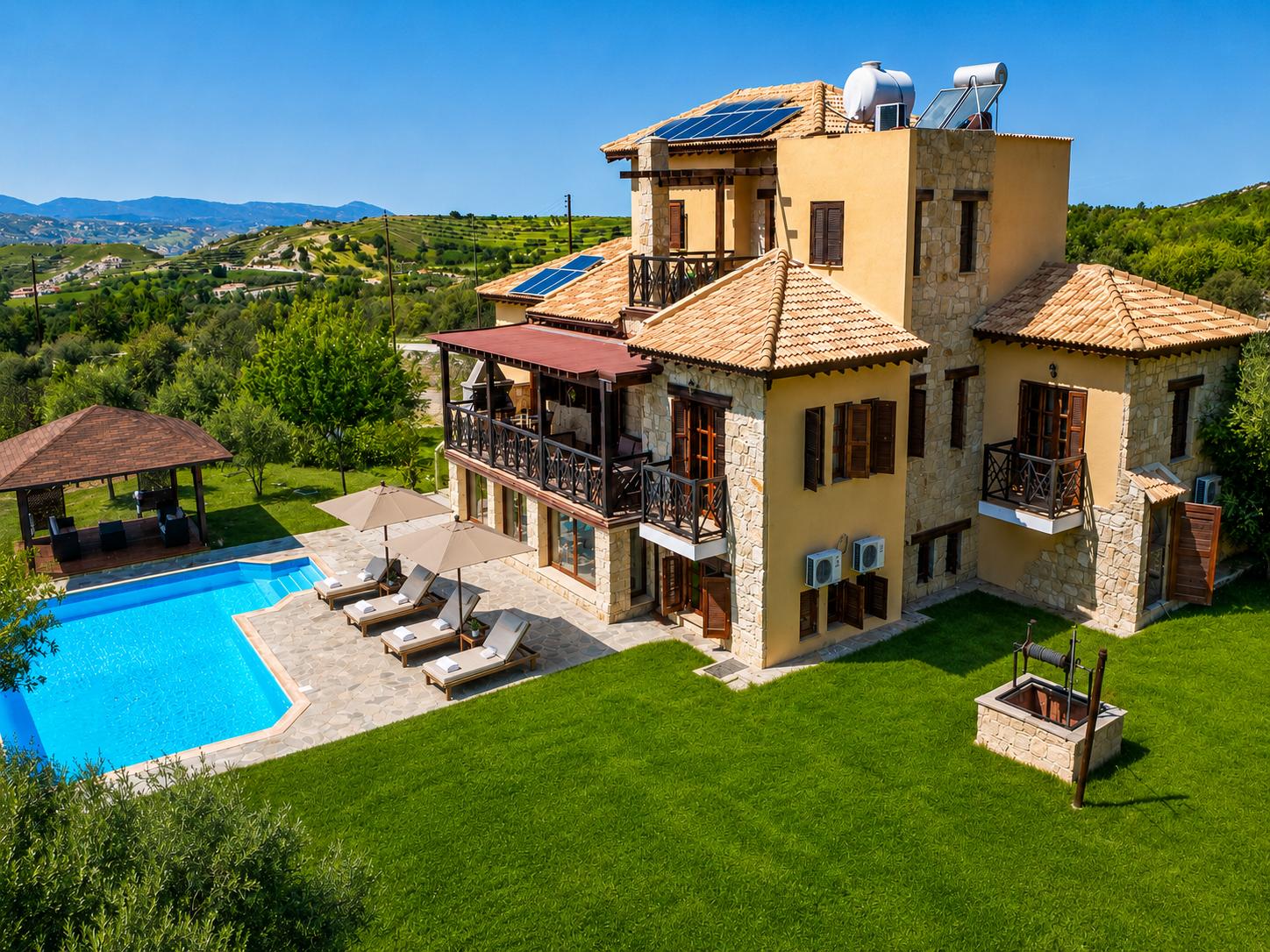 ,A luxurious hillside villa with a private pool, spacious terraces, and beautiful countryside views.