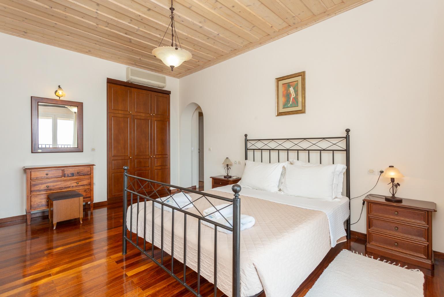 Double bedroom with en suite bathroom, A/C, and upper terrace access with panoramic sea views