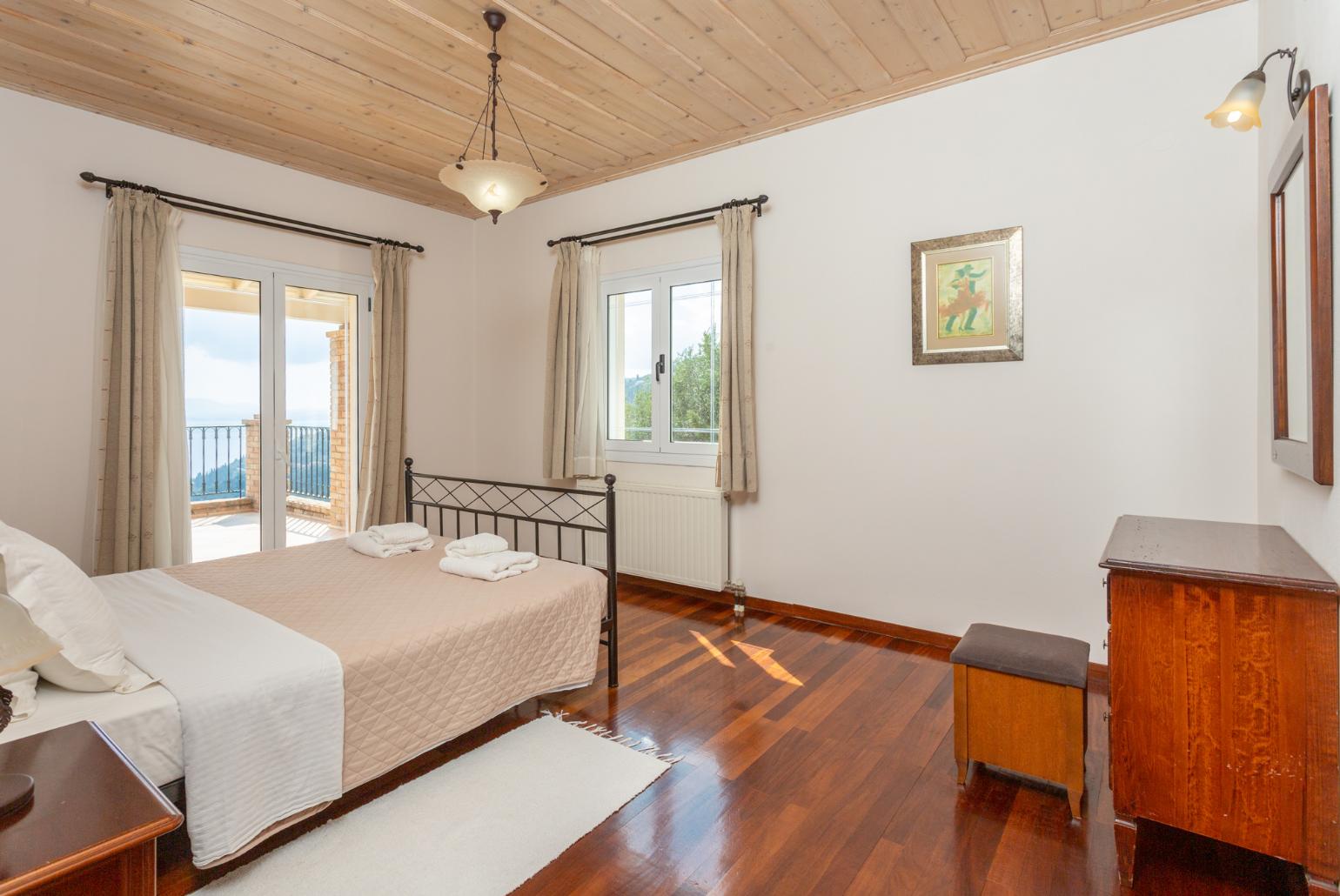 Double bedroom with en suite bathroom, A/C, and upper terrace access with panoramic sea views