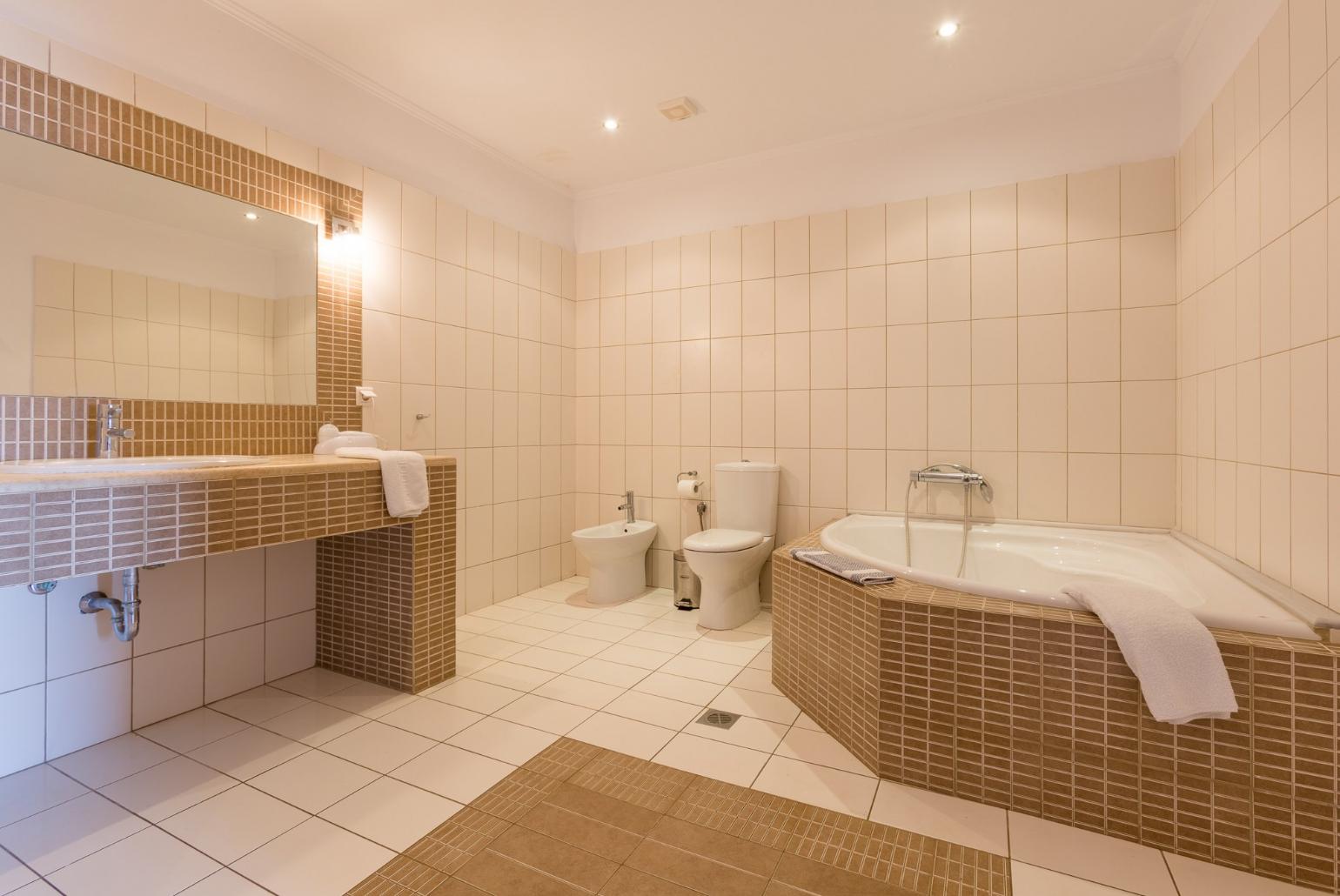 Family bathroom with bath and shower