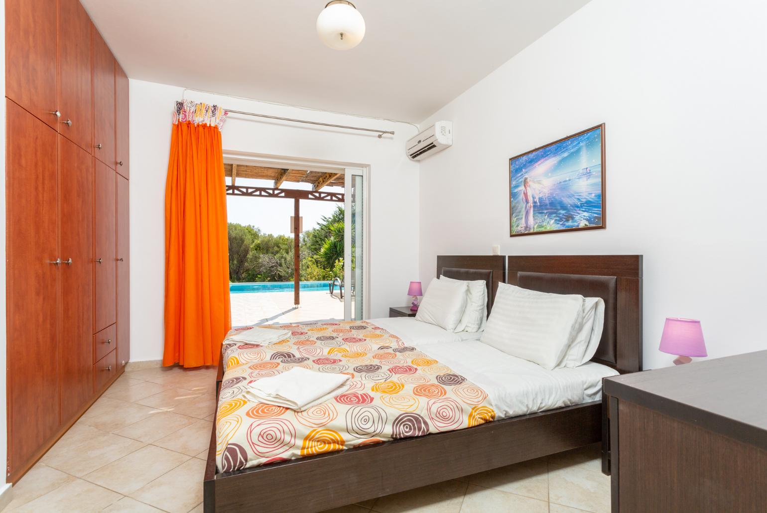 Twin bedroom with en suite bathroom, A/C, and terrace access