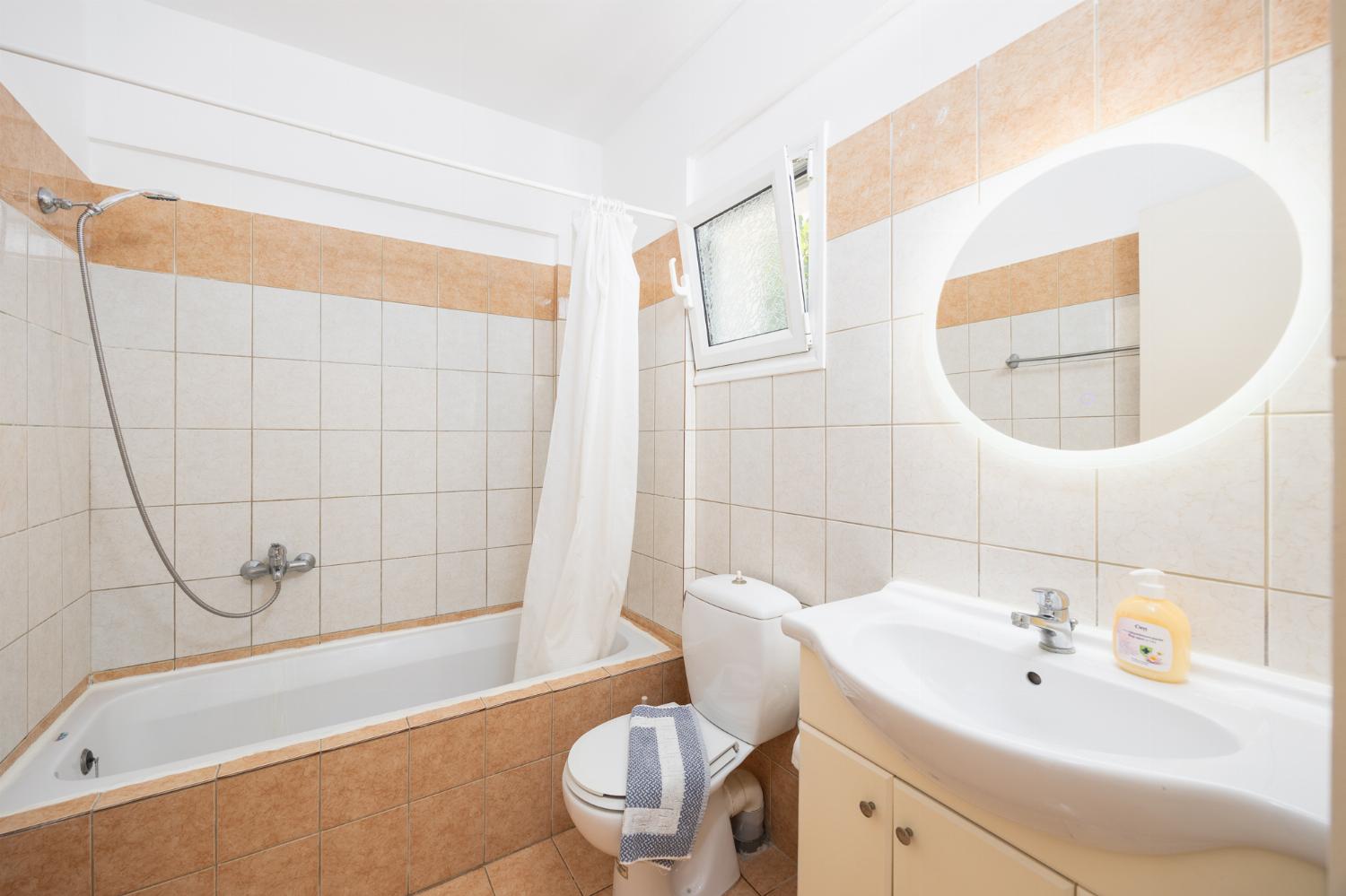 En suite bathroom with bath and shower