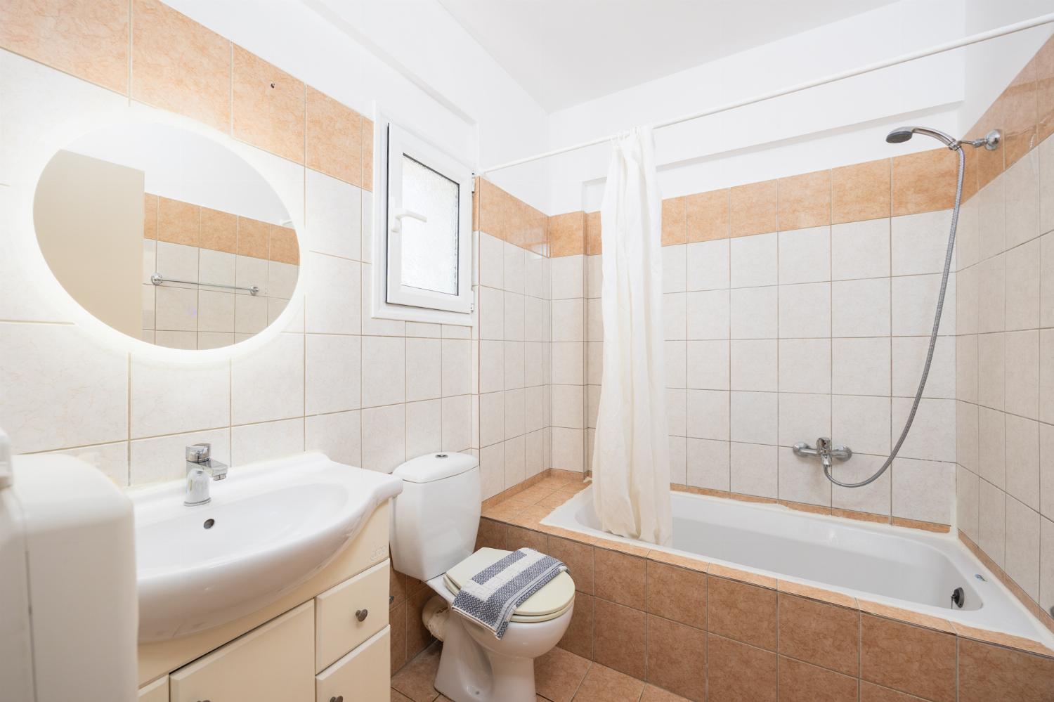En suite bathroom with bath and shower